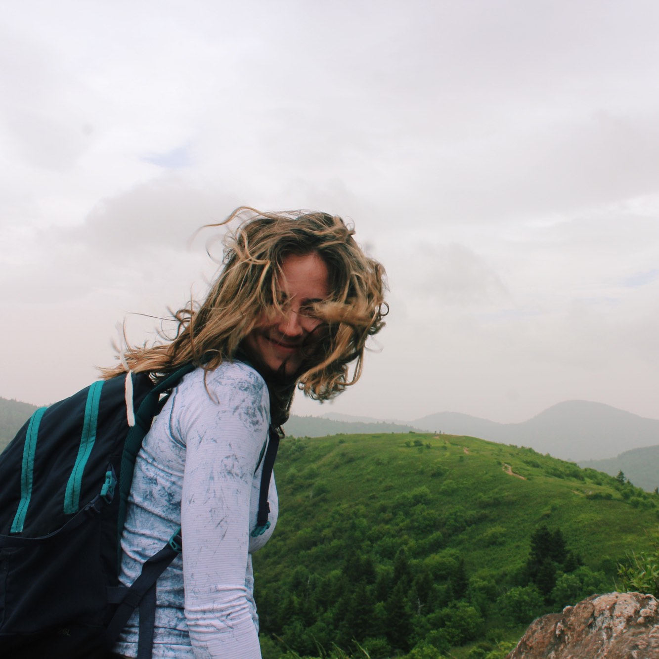 Girl backpacking through NC mountain range